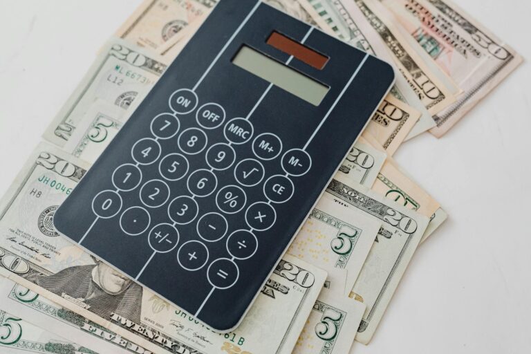Close-up of a calculator atop US dollar bills, symbolizing financial planning and budgeting.